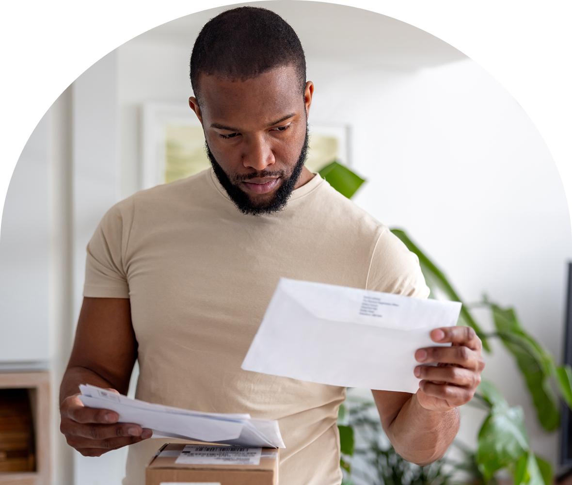 Man reading letters at home
