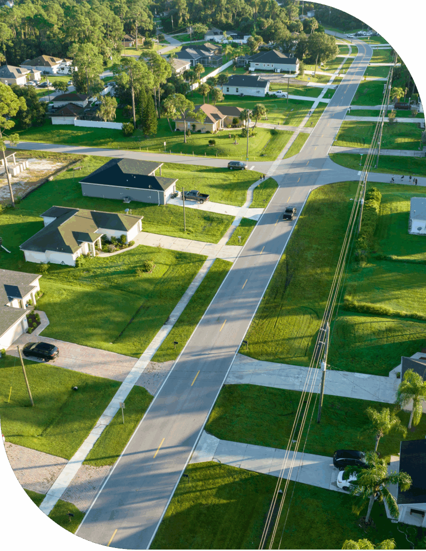 Aerial view of a suburban neighborhood with houses and streets.