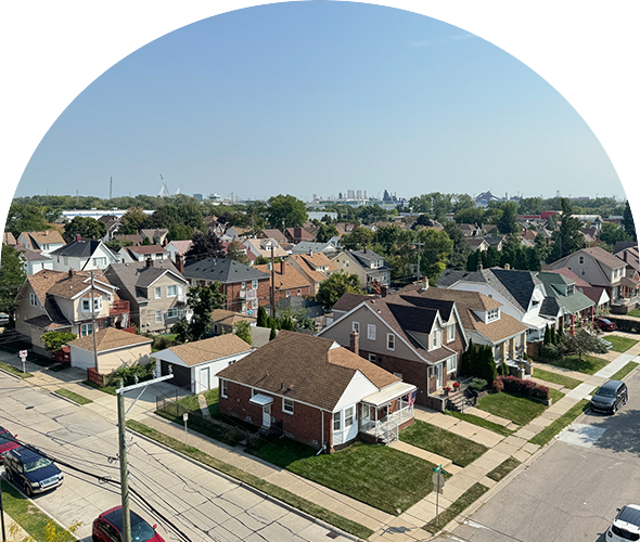 A suburban neighborhood with single-family homes and clear skies.