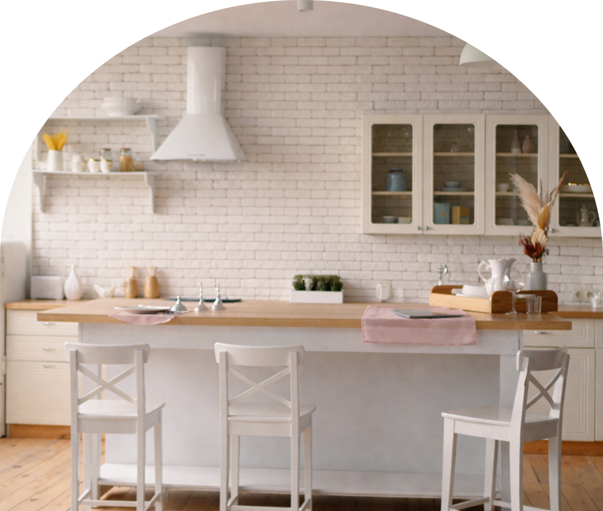 Bright modern kitchen with white cabinetry and island seating.