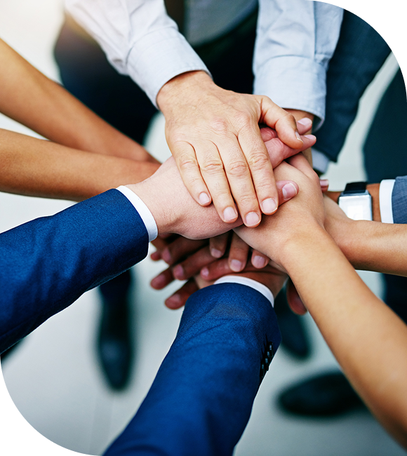 Diverse team stacking hands in unity and teamwork.